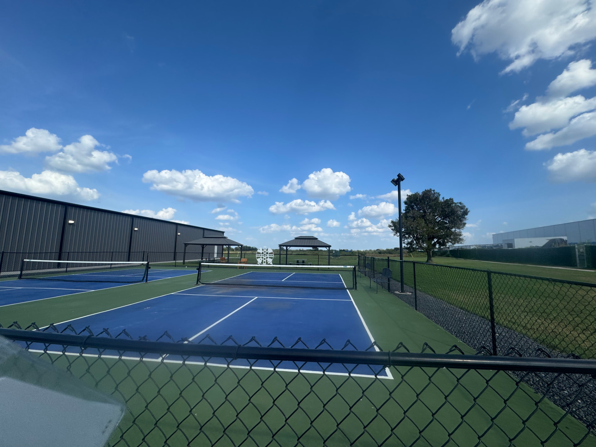 Pickleball courts under a blue Texas sky at Hyperloop Plaza