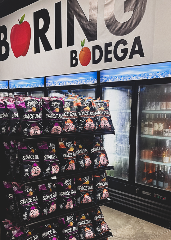 Snack racks and coolers inside The Boring Bodega