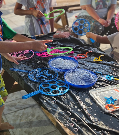 Kids making giant bubbles on the plaza