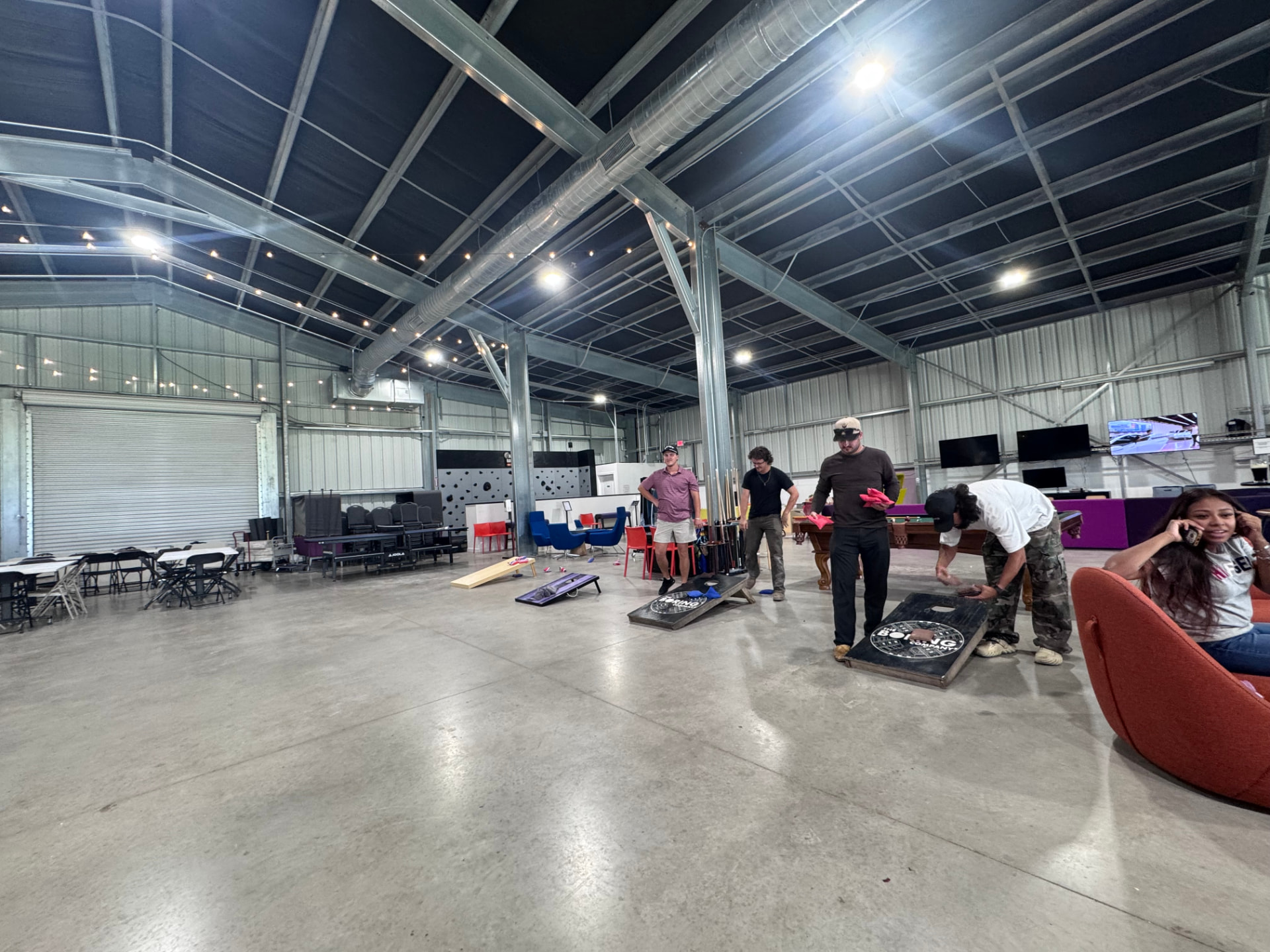 Guests playing Boring Company cornhole inside the plaza