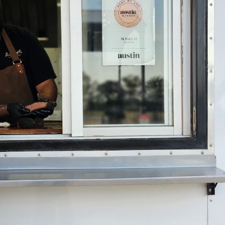 Chef at the Si Baby BBQ window
