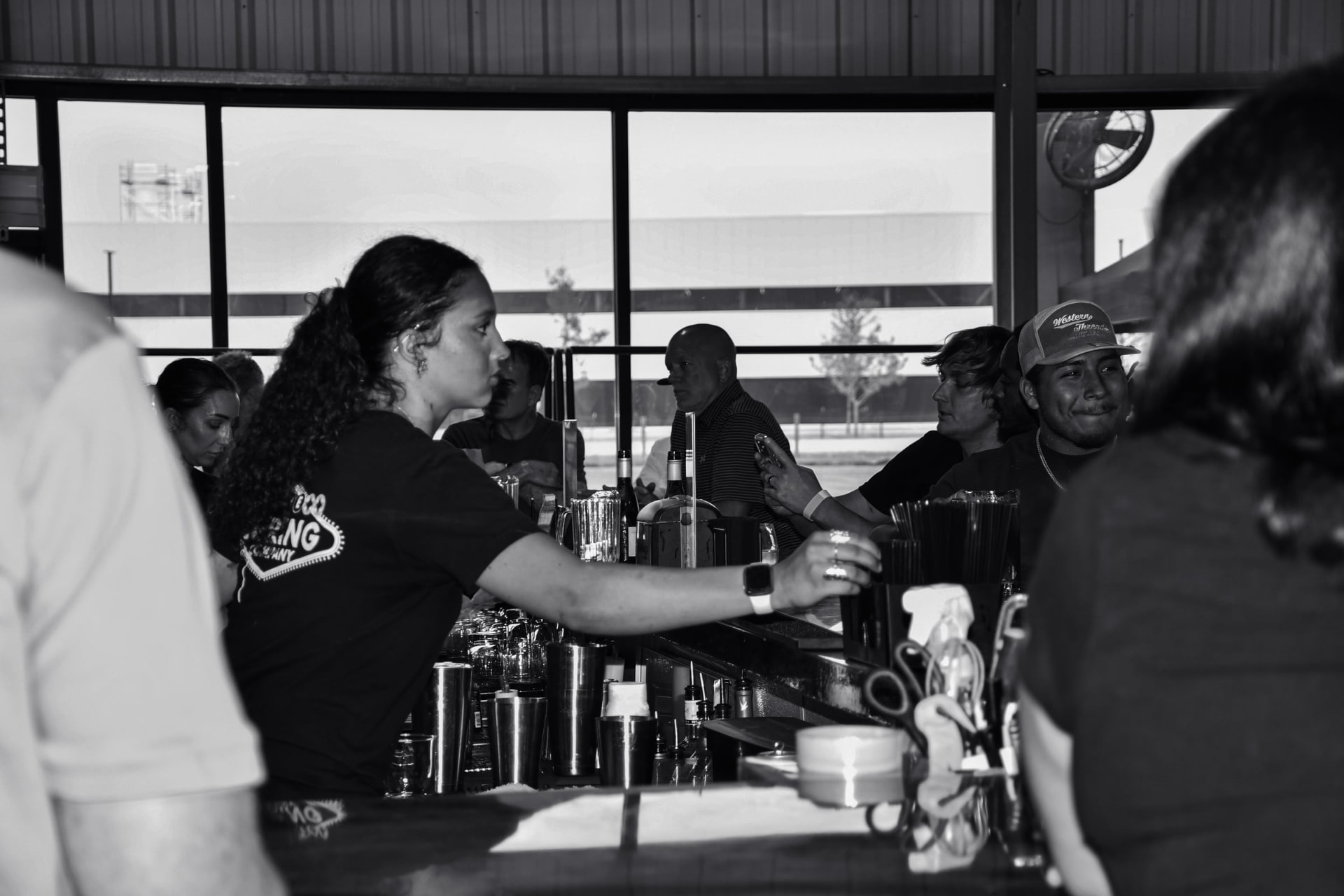 Bartender pouring a drink at the Prufrock Pub bar